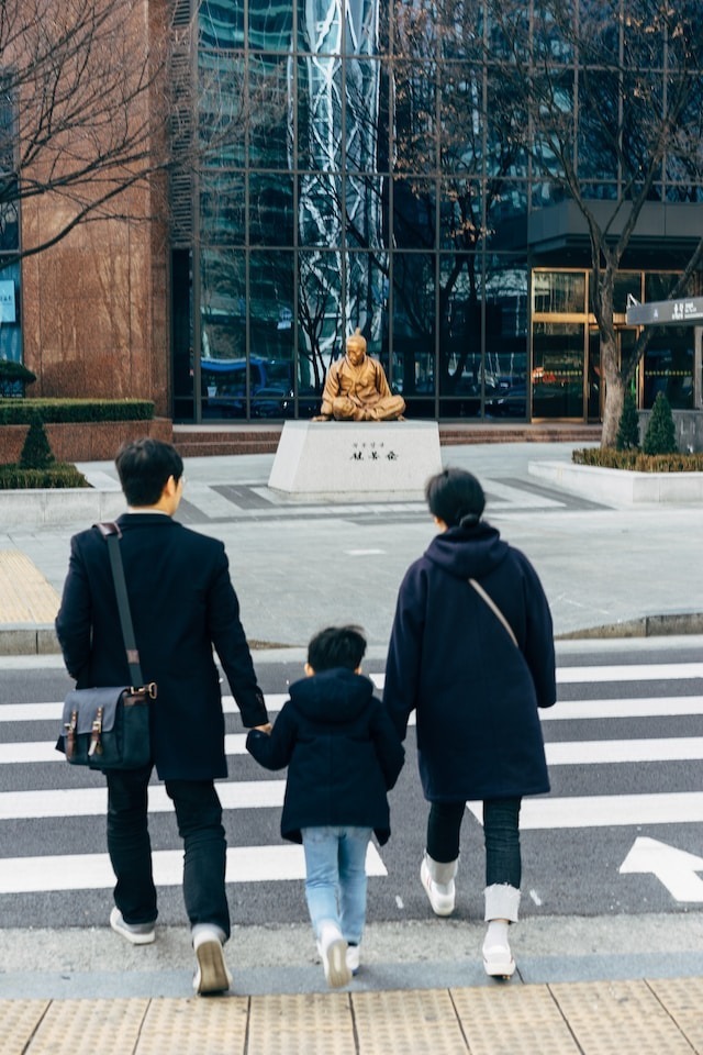 Mother, father and son are crossing the crosswalk
